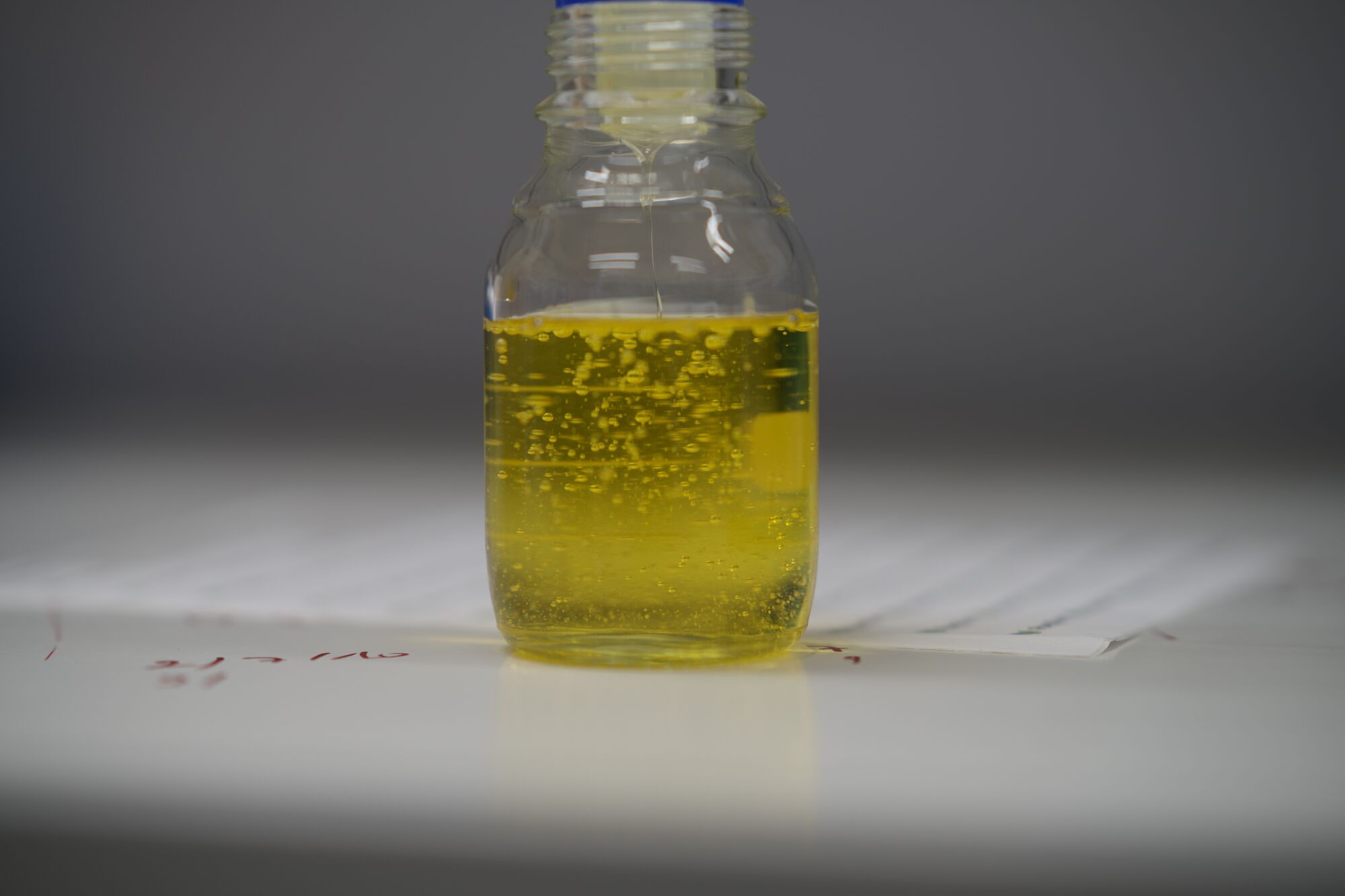Sample bottle with yellow surfactant liquid