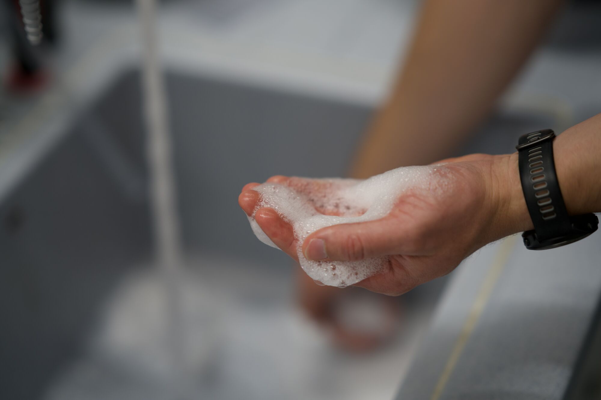 Foam cupped in a hand at the sink