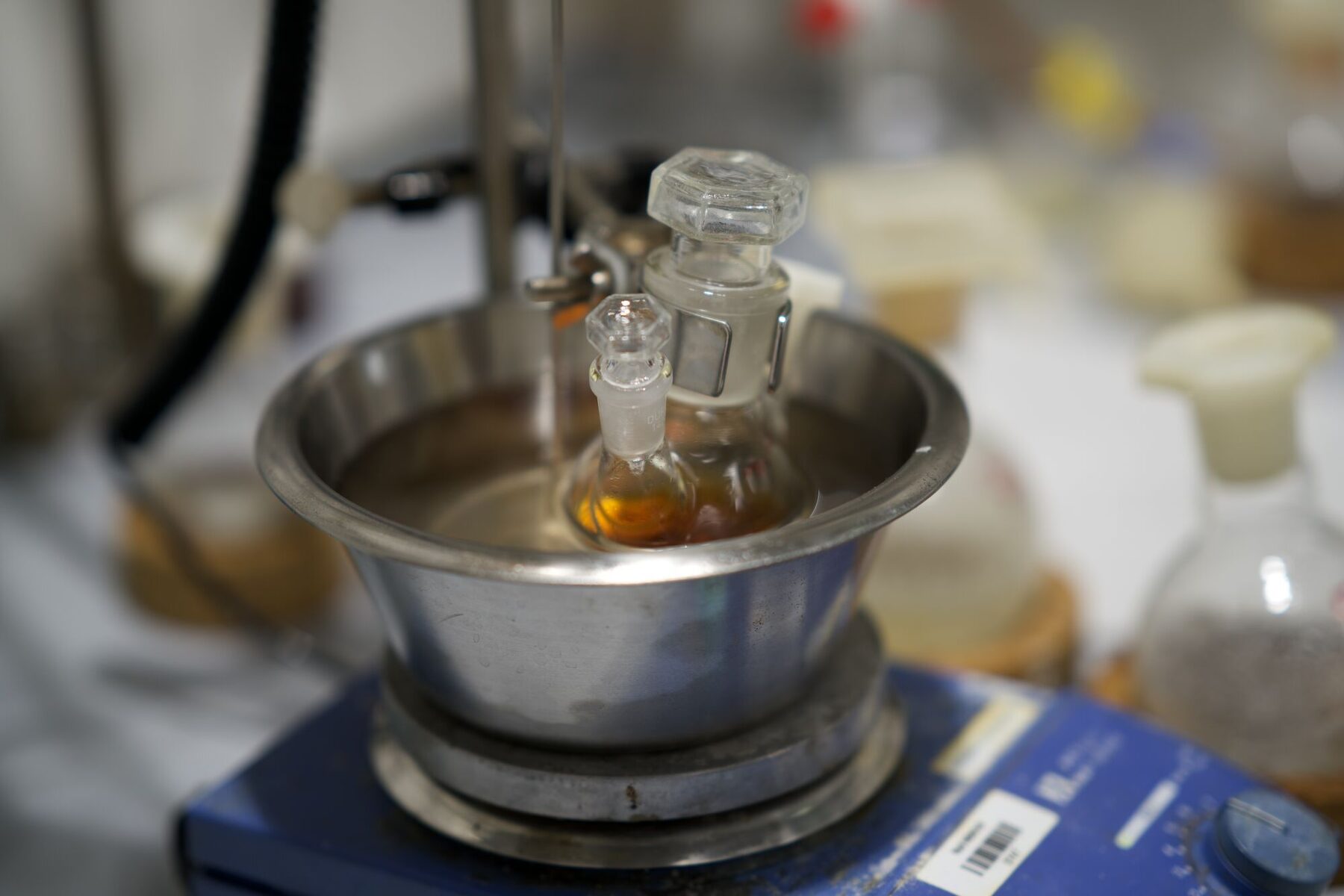 Amber surfactant dripping into the flask