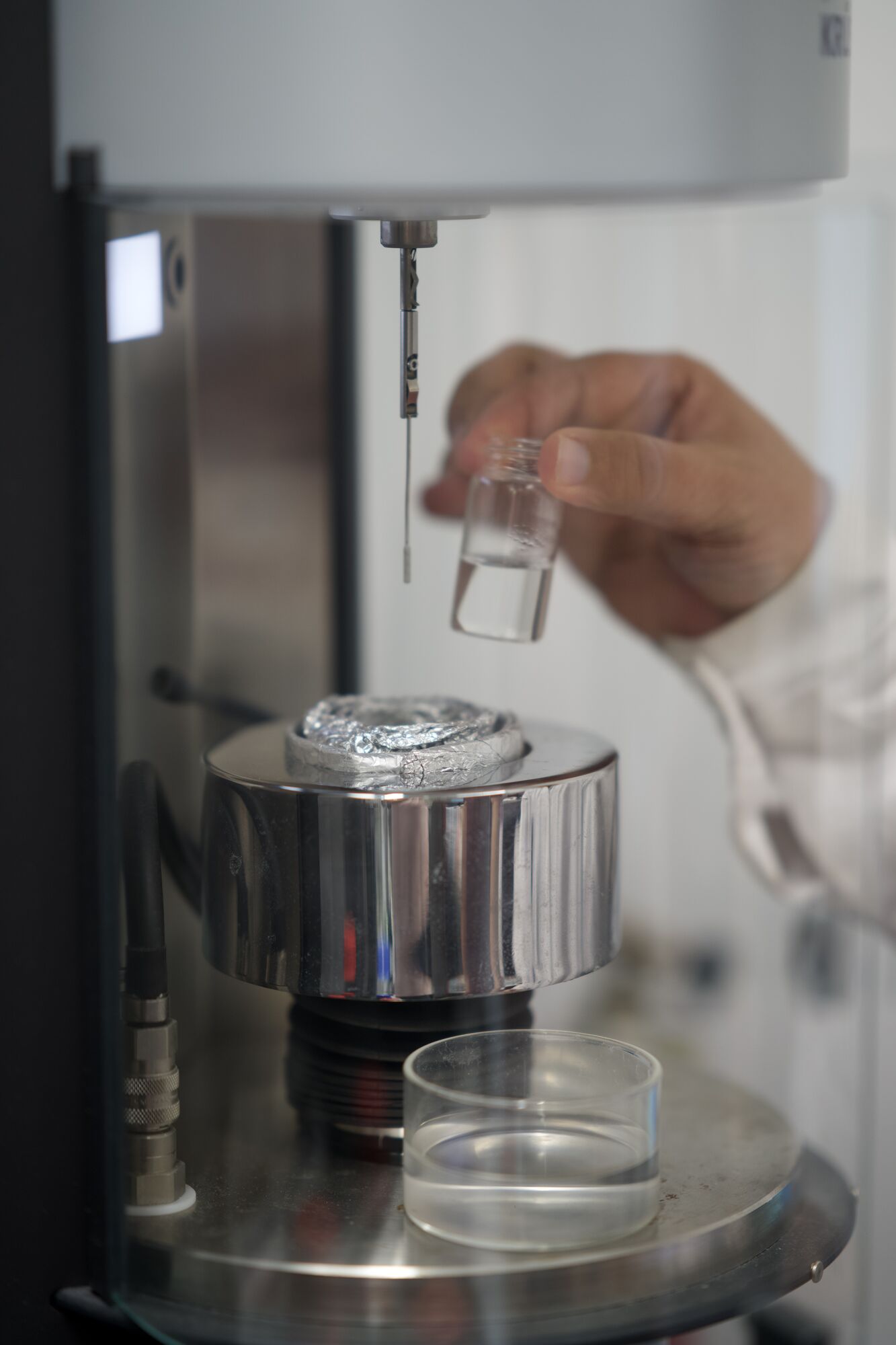 Technician placing a vial in the rheometer